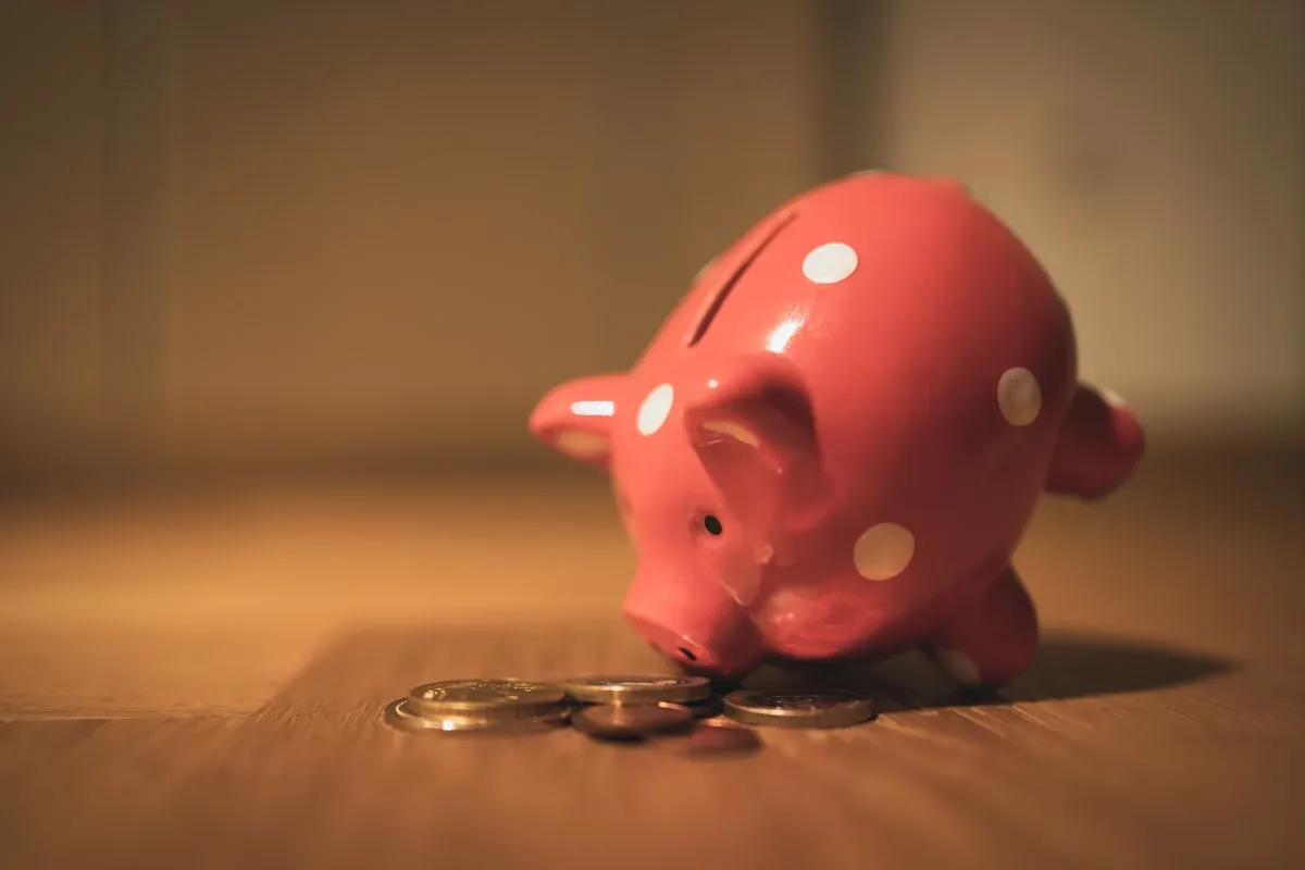 Piggy bank on coins representing the AUD 2,500 Australia student visa fee and savings needed by Indian students in 2026
