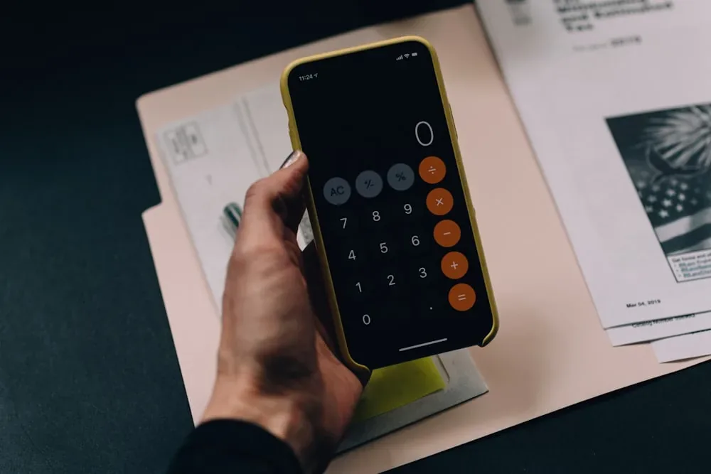 Calculator and financial documents representing budgeting for the higher Australia student visa fee
