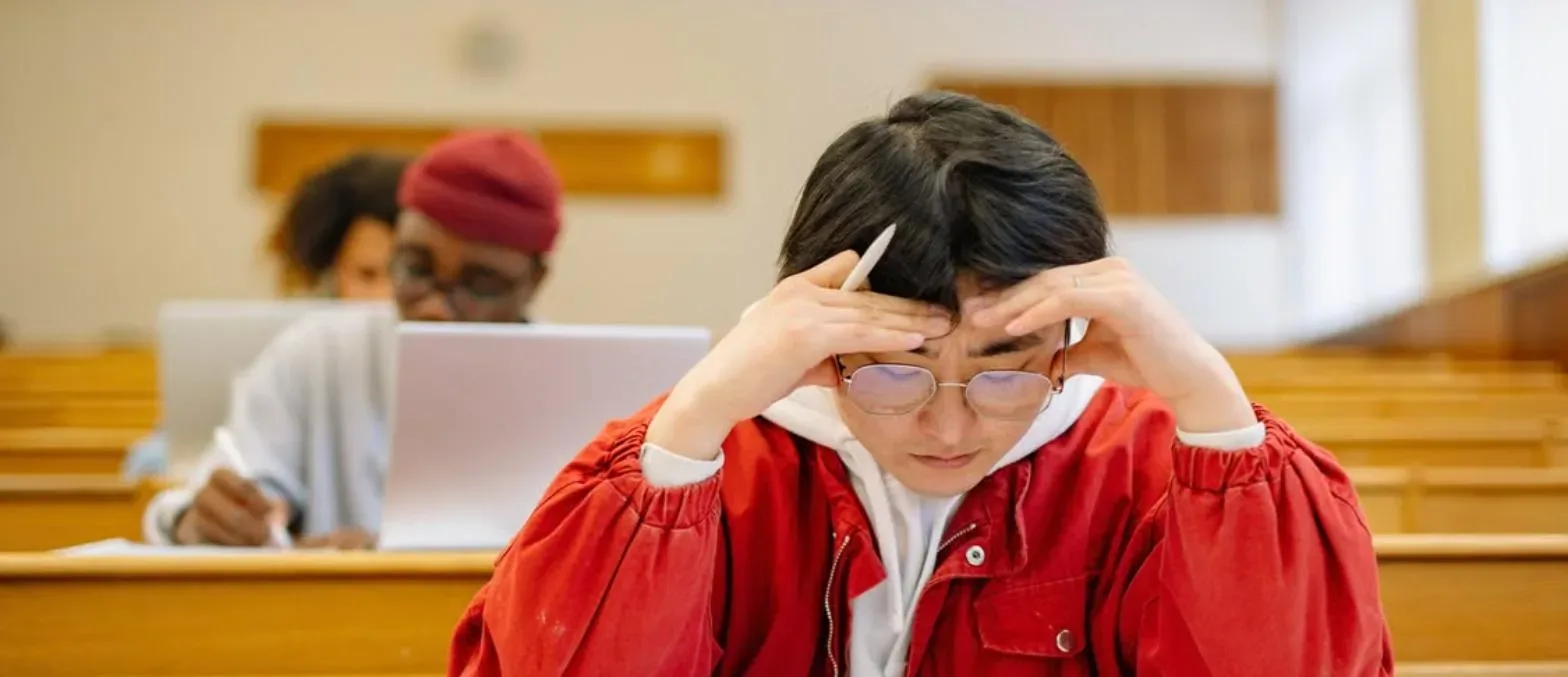 Indian student taking the dMAT exam in a university lecture hall