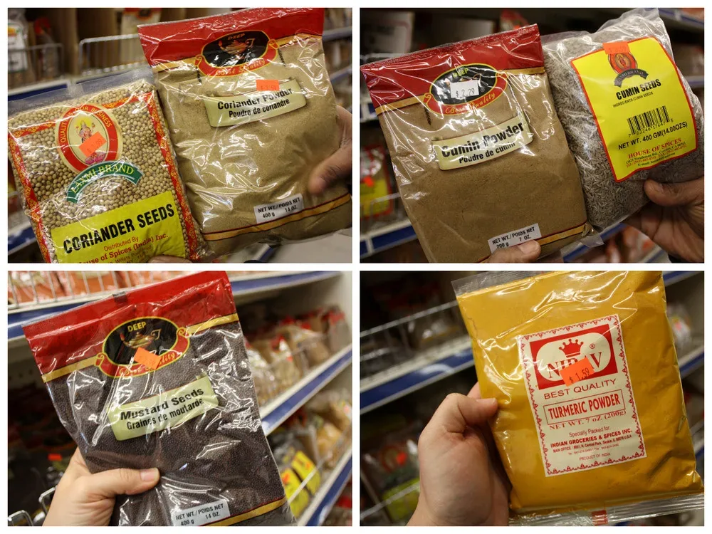 An assortment of common Indian spices in bowls, like those found at an Indian grocery store