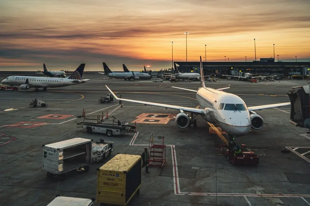 Airport terminal with aircraft representing travel disruption for Indian nationals in Australia